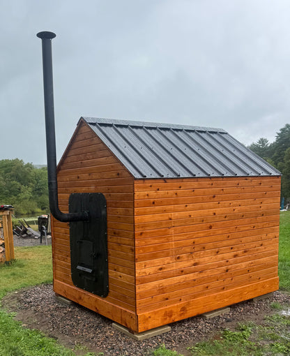 Henki rear loading wood sauna stove installed in outdoor cedar sauna backyard setting